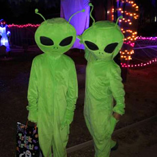 Two children dressed as aliens.
